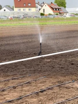Artificial irrigation on fields in germany. Shows an irrigation system. Nurem Stock Photos