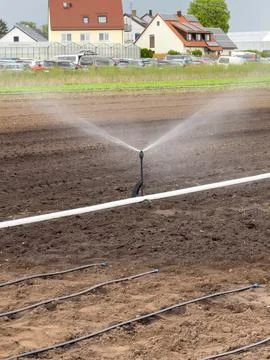 Artificial irrigation on fields in germany. Shows an irrigation system. Nurem Stock Photos