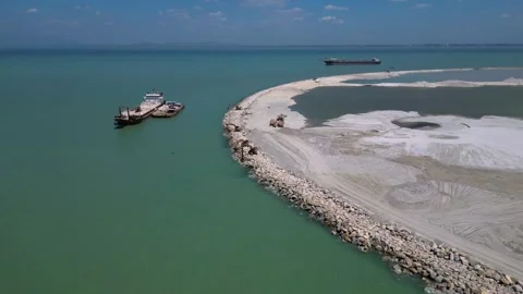 Artificial island reclamation construction excavator. Lovely aerial view drone Stock Footage 344603997