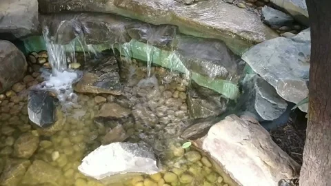 An artificial low height water fall with crystal clear water, India Stock Footage 134336429