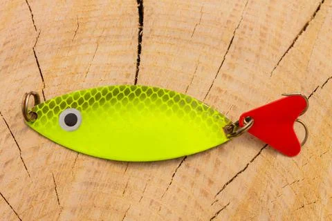 Artificial metal baits on a wooden background. Homemade fishing gear. baits f Stock Photos