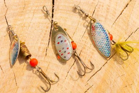 Artificial metal baits on a wooden background. Homemade fishing gear. baits f Stock Photos