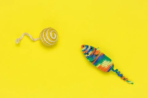 Artificial mouse and ball for playing cats on a bright yellow background. Vie Stock Photos