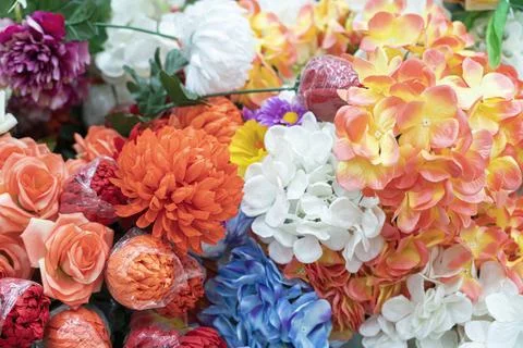 Artificial multicolored flowers close up as background Fotos Stock