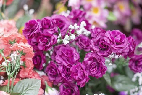 Artificial multicolored flowers close up as background Stock Photos