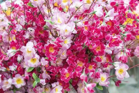 Artificial multicolored flowers close up as background Stock-Fotos