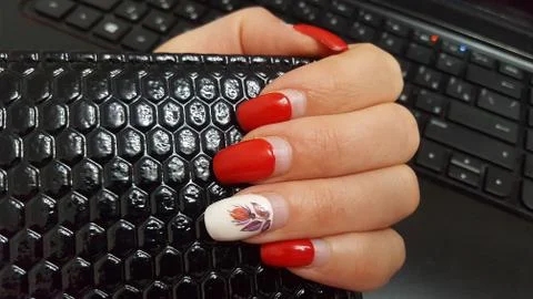 Artificial nails need to be adjusted. Manicure, the nails, red nail Polish. Stock Photos