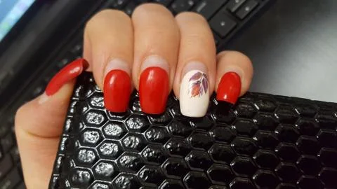 Artificial nails need to be adjusted. Manicure, the nails, red nail Polish. Stock Photos