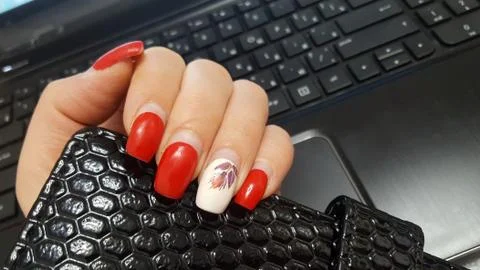 Artificial nails need to be adjusted. Manicure, the nails, red nail Polish. Stock Photos