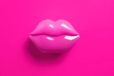 Artificial pink lips shape on pink background. Flat lay. Stock Photos