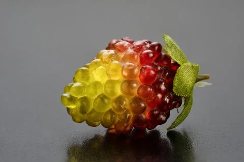 Artificial plastic small yellow-red raspberry Foto stock