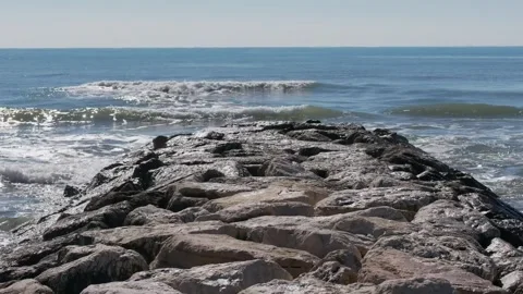Artificial reef made of large rock boulders extending into the sea, Latina Lido Stock Footage 330779577