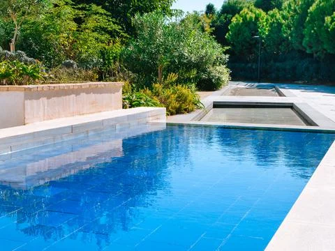 Artificial reservoir whose bottom is decorated with blue tiles on a sunny day Stock Photos