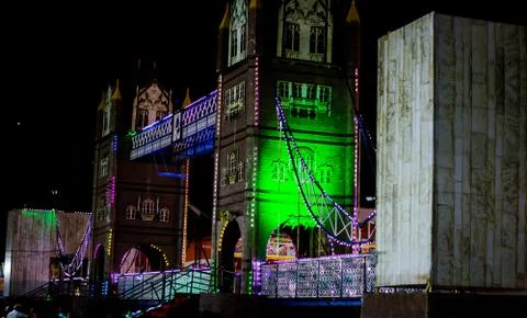 Artificial river bridge covered in lights in diwali fair Stock-Fotos