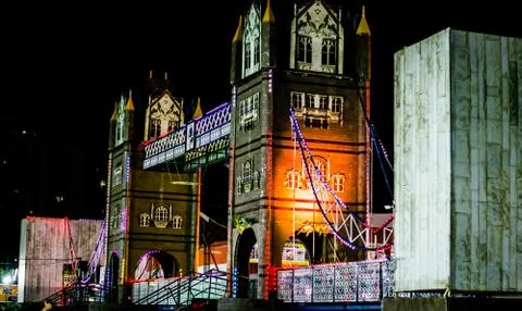 Artificial river bridge covered in lights in diwali fair Stock Photos