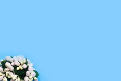 Artificial roses on a blue background frame for text. copy space Stock Photos