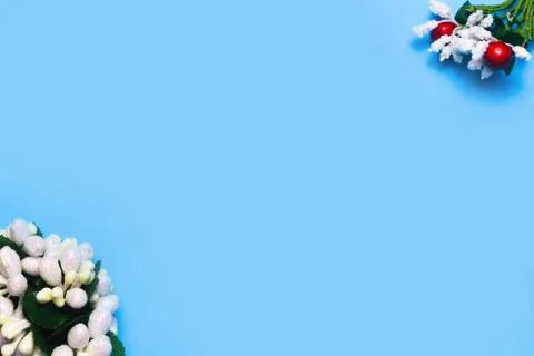 Artificial roses on a blue background frame for text. copy space Stock Photos