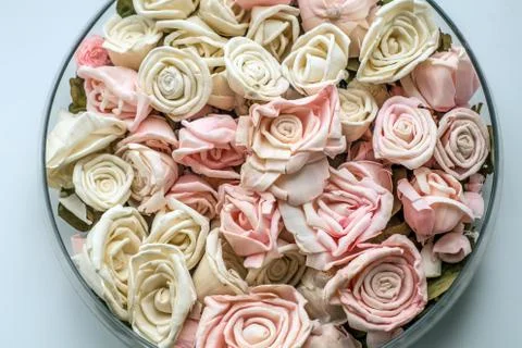 Artificial roses in a dish Stock Photos