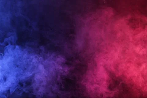 Artificial Smoke in red-blue light on black background Foto stock