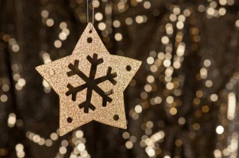 Artificial snowflake in gold Stock Photos