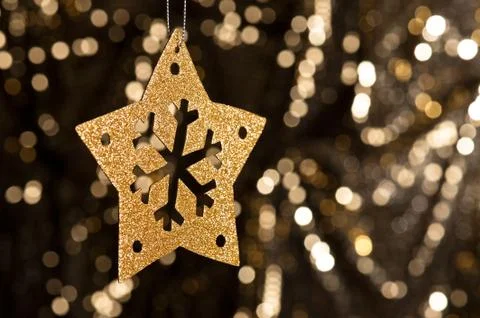Artificial snowflake in gold Stock Photos