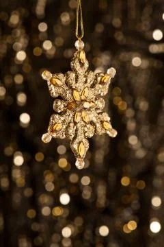 Artificial snowflake in gold Stock Photos