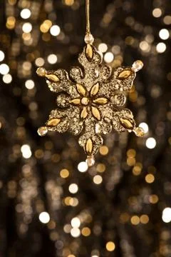 Artificial snowflake in gold Stock Photos