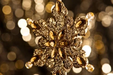 Artificial snowflake in gold Stock Photos