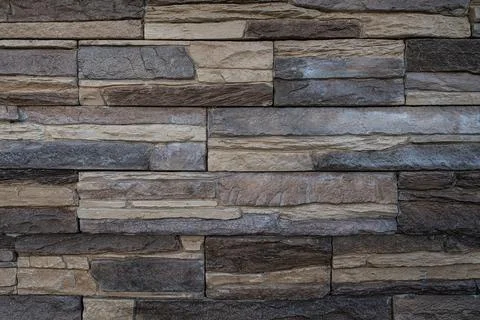 Artificial stone brick wall with the look of pressed together flat stones Stock Photos