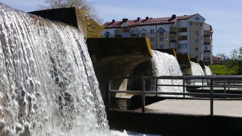 An artificial threshold of the river. Water falls from the top, with large concr Stock Footage 85283079