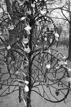An artificial tree made of iron rods, hung with tourist door locks. Stock Photos