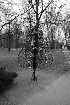 An artificial tree made of iron rods, hung with tourist door locks. Stock Photos