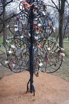 An artificial tree made of iron rods, hung with tourist door locks. Stock Photos