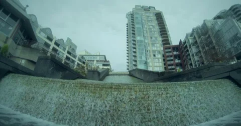Artificial urbab waterfall, Vancouver, cloudy day, skyscrapers Stock Footage 55904037