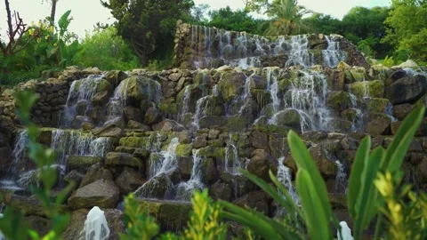 Artificial waterfall on the background of green plants Stock Footage 239546178