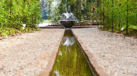 Artificial waterfall in botanic garden Stock Footage 64326997