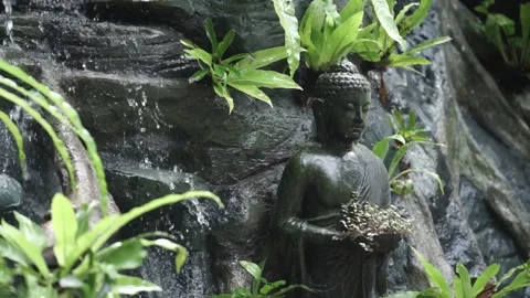 Artificial waterfall with Buddha statue Stock Footage 260213194
