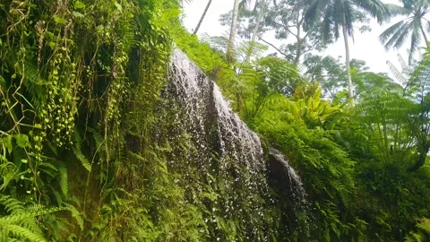 An artificial waterfall cascading from above Stock Footage 304038461