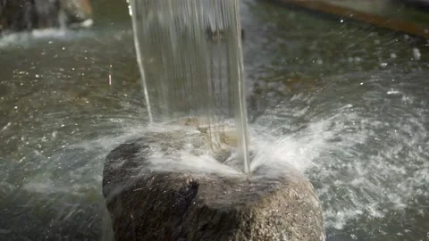 An artificial waterfall falls on a granite stone. Stock Footage 142222861