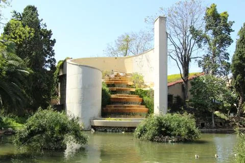 Artificial waterfall on the pond of the park Stock Photos