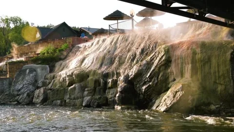 Artificial Waterfall Structure near Buildings and Bridge Underpass Stock Footage 311726862