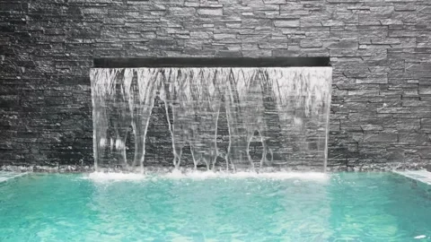Artificial waterfall in turquoise water pool Stock Footage 304742132