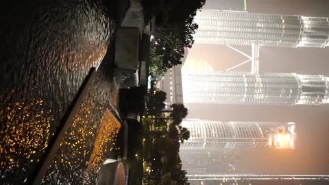 Artificial waterfalls against the backdrop of a huge city. (vertical video) Stock Footage 154160459