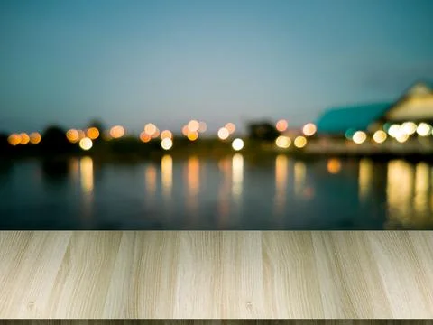 Artificial wood table in front. Blurred background, lagoon and spherical bokeh Stock Photos