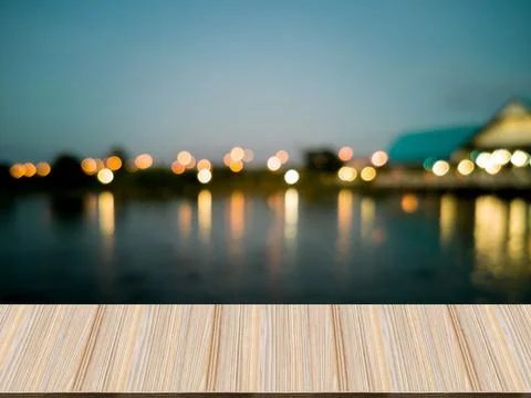 Artificial wood table in front. Blurred background, lagoon and spherical bokeh Stock-Fotos