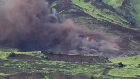 An artillery fire impacting hillside Stock Footage 137101832