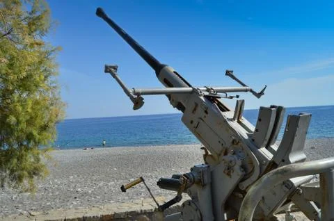 Artillery piece of the Second World War in front of the ocean Stock Photos