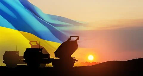 Artillery rocket system are aimed to the sky at sunset with Ukrainian flag Stock Photos