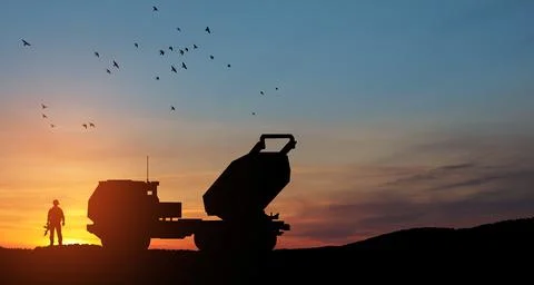 Artillery rocket system are aimed to the sky and soldier at sunset. Multiple Foto stock