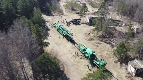 Artillery weapons from the Second World War on a railway transporter in a woods Stock Footage 173408582